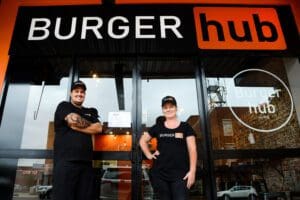 2 people standing infront of Burger Hub Store front